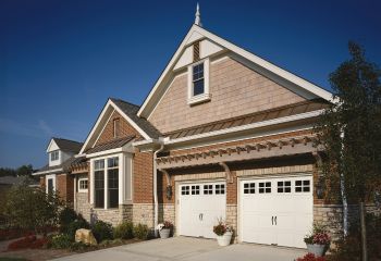 After installation, the Casa Grande home features two new Craftsman garage doors with decorative windows and hardware, enhancing the home’s exterior.