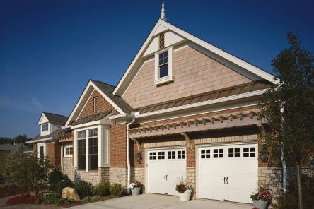 After installation, the Casa Grande home features two new Craftsman garage doors with decorative windows and hardware, enhancing the home’s exterior.