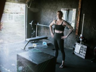 Turn Your Garage Into a Private Gym in Casa Grande Woman exercising inside a private garage gym conversion in Casa Grande with workout equipment.